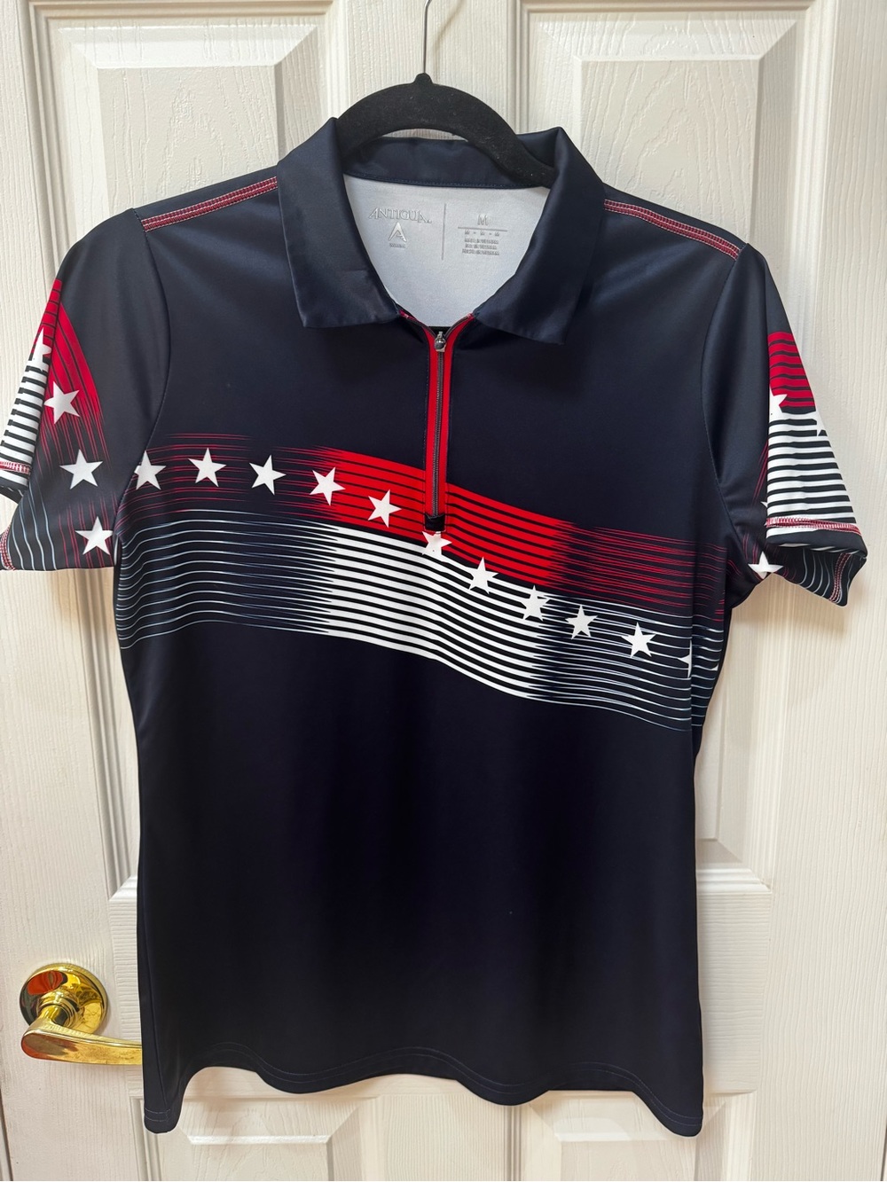 Antigua Black Golf Polo with Red and White Star Stripe Accents
